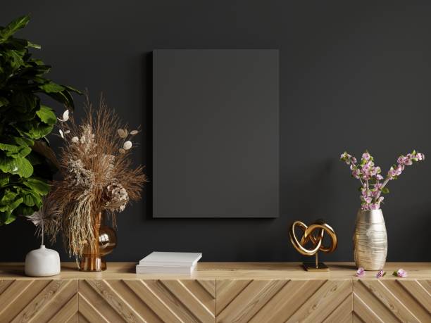 istock Mockup poster frame on wood cabinet in empty dark room background. 1450443783