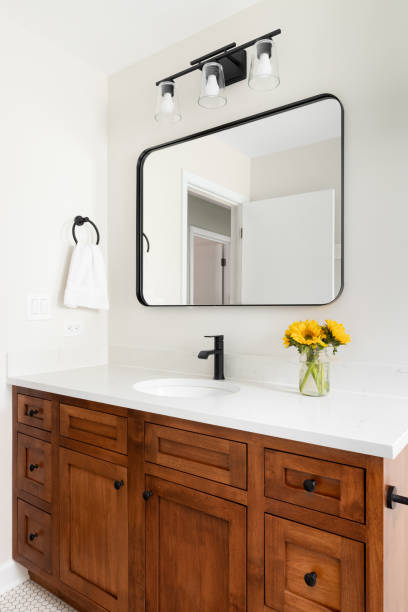 istock A bathroom with a wood cabinet and marble countertop. 1450445595