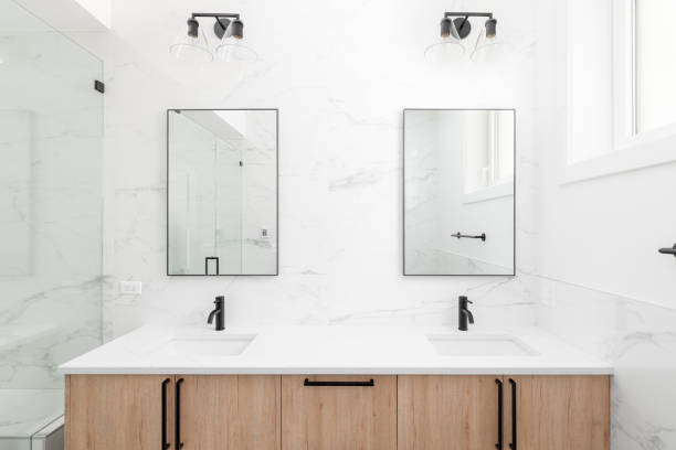 istock A bathroom with a wood cabinet and marble countertop. 1450445671