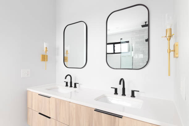 istock A bathroom with a wood cabinet and gold sconces. 1450445901
