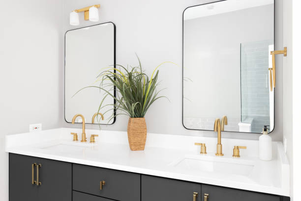 istock A bathroom with a  grey cabinet and gold faucets. 1450445946