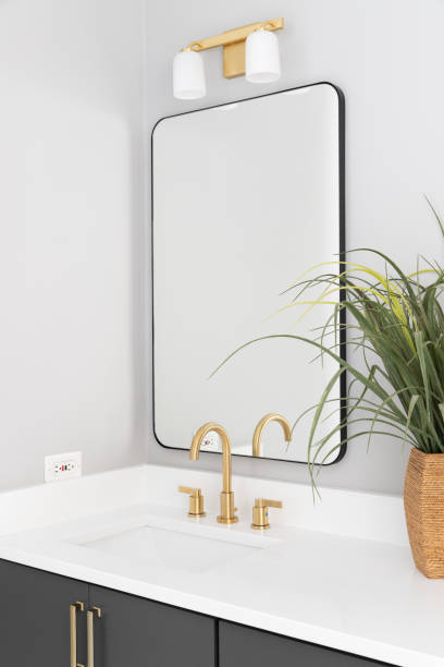 istock A bathroom with a  grey cabinet and gold faucet. 1450445949
