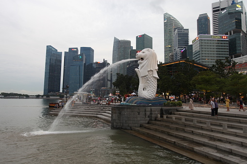 The Singapore Merlion Fountain and Singapore Financial District during evening time.