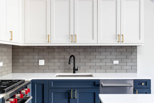 istock A kitchen sink detail shot with white and blue cabinets. 1450448910