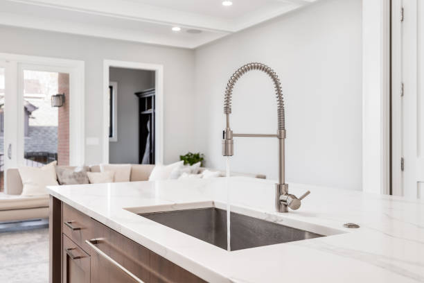 A kitchen sink with running water in a modern kitchen.