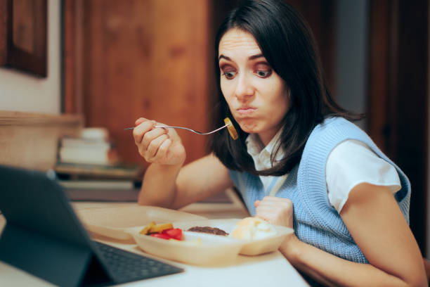 istock Busy Woman Multitasking Eating in Front of her Pc Tablet 1450448994