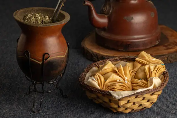 Fried pastries stuffed with sweet potato or quince with yerba mate and a kettle. Typical Argentine food.