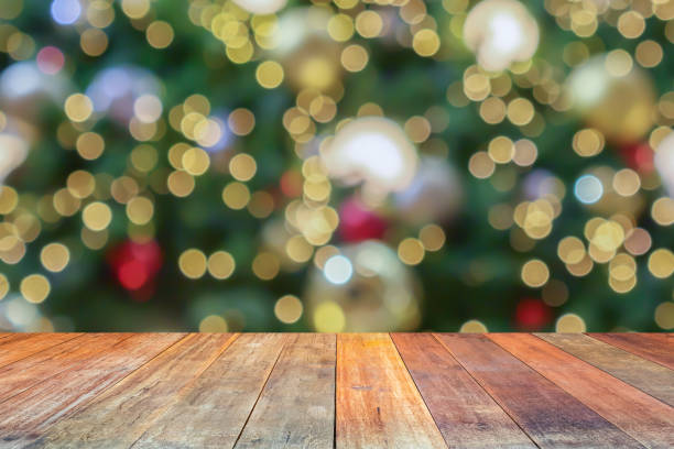 istock Empty wood table top with blur Christmas tree with bokeh light background 1450457264
