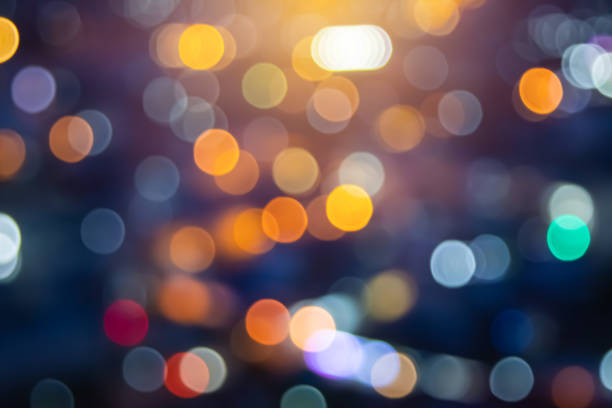 istock Abstract city lights blur blinking background. Soft focus horizontal long banner. Bokeh sparkles colorful defocused on dark texture for night party city. Abstract blurred pattern template. 1450457590