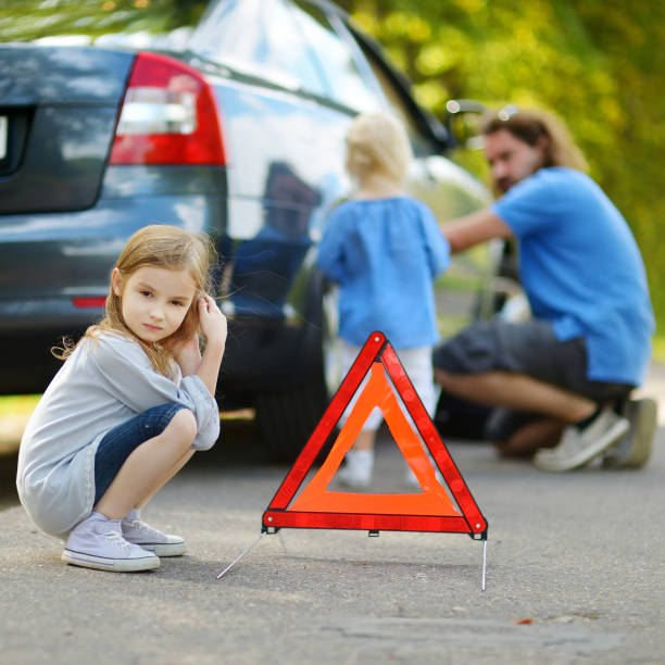 istock Happy family changing a car wheel 1450458293