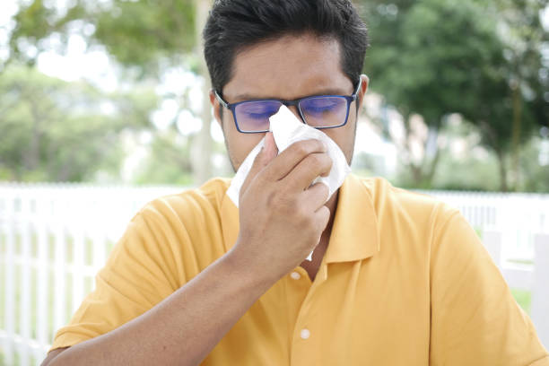 istock Sick man got flu allergy sneezing and blowing nose 1450459338