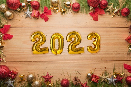 2023 with a Christmas decoration on wooden background. Happy New Year 2023
