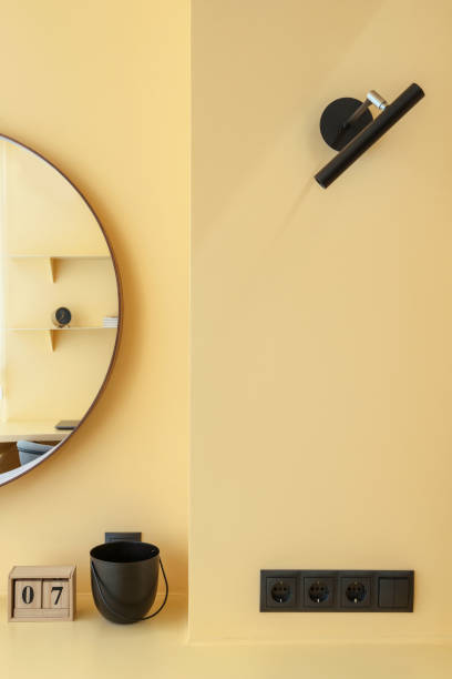 lamp and electrical socket in room with modern design and bright wall