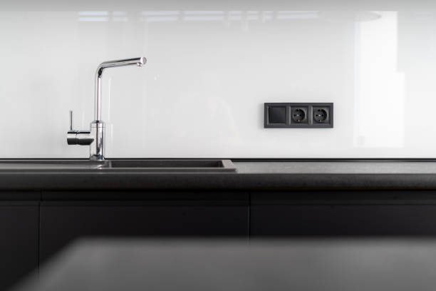 istock modern water tap at kitchen with dark furniture 1450474875