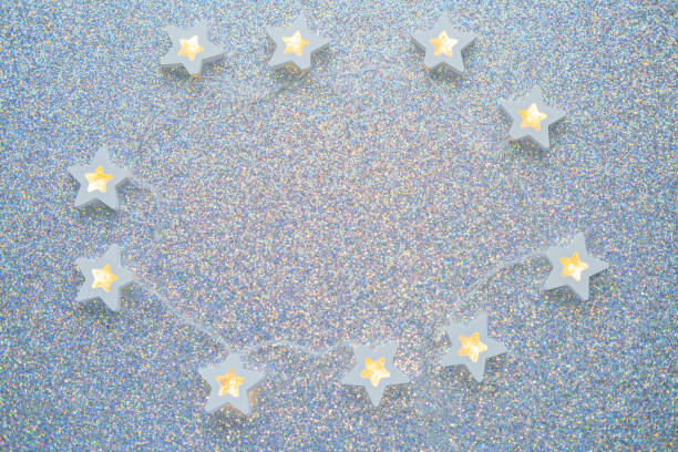 istock Christmas silver background with white lightbulb stars. 1450480615