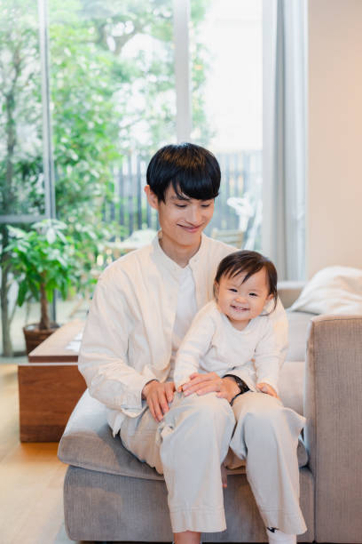 istock Baby playing at home with father 1450483187