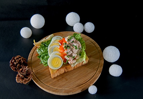 Traditional Swedish open sandwhich. Toast bread topped with shrimps, mayonnaise, boiled eggs and fish roe.