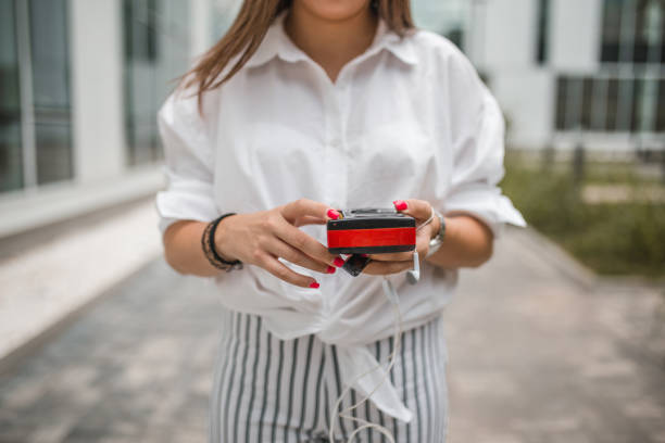 istock Front view of an unrecognizable woman holding a Walkman 1450494463