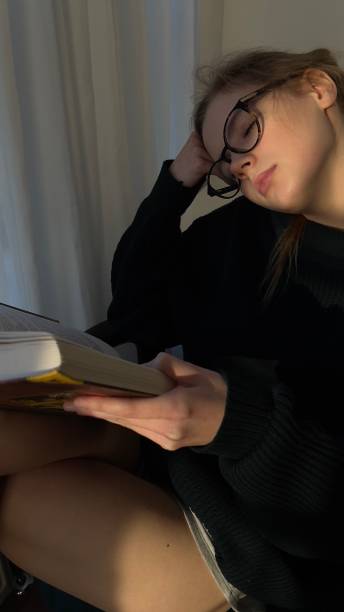 istock reading book young girl with glasses 1450504016