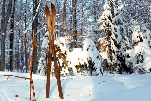 Pair of old wooden skis and ski poles.