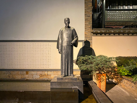 Kunming, Yunnan- December 17, 2022:  Kunming is the capital of Yunnan Province in Southwest border of China. Because the mild climate, it is called the City of Spring and an attractive travel destination. Here is the statue of Chi Wang in the ancient Qianwang (King of Wealth) street.