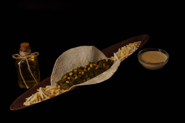 istock taco with spinach and pine nuts and various types of cheeses as garnish and black background 1450519007
