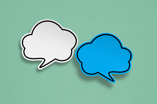 white and blue cloud speech bubble grunge paper cut on grunge green background. Conceptual image about communication and social media, customer feedback