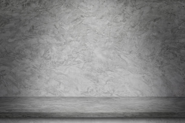 istock empty room of concrete wall and floor with light for design. 1450527812