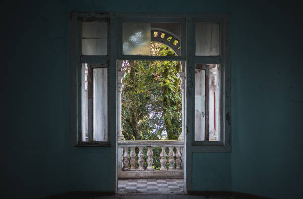 View from abandoned building room through open balcony door.