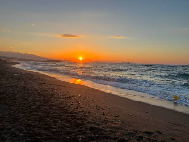 istock Beautiful orange sunset over the sandy sea shore 1450530088