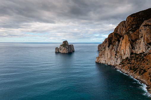 A drone landscape view of the cliffs and sea stacks at Porto Flavia on Sardinia