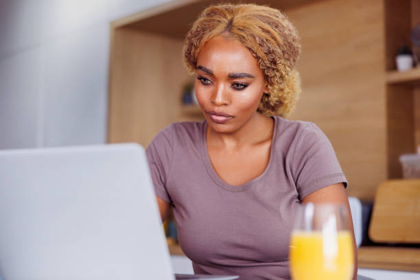 istock Female freelancer having breakfast and working from home 1450533413