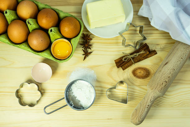 istock Background wallpaper for cooking. On the table, sprinkled with flour, there are baking tools and kitchen equipment. A set of cookie cutters of different types. 1450541821
