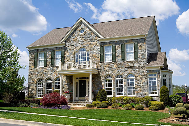 Front Stone Faced Single Family House Home Suburban Maryland Well landscaped stone single family house.  Home is a center hall colonial in suburban Maryland, United States.  - see my lightbox for more house images.   colonial style photos stock pictures, royalty-free photos & images