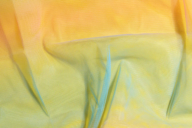 istock Silk yellow fabric transparent texture. Silk fabric, no doubt, is the best solution for your projects. 1450545448
