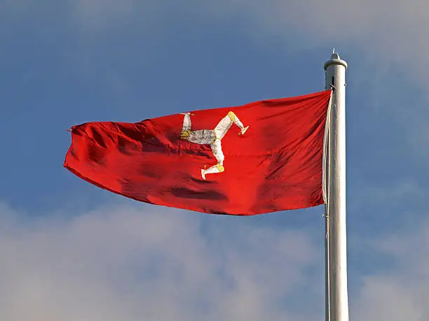 The Triskelion, the flag of the Isle of Man, flying on Tynwald Hill. The three legs is an iconic symbol. The motto 'quocunque jeceris stabit' (any way you throw me, I will stand) is a potent metaphor for Manx independence and resilience.        