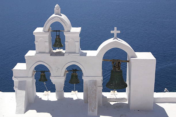 Greek church bells agains the blue sea stock photo