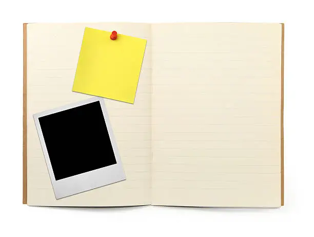 Photo of exercise book with photo frame and yellow note