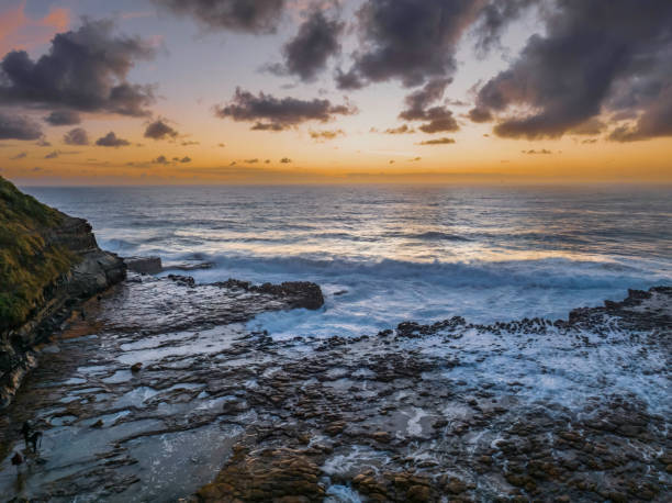 istock Surfs up sunrise at the seaside with scattered clouds 1450552899