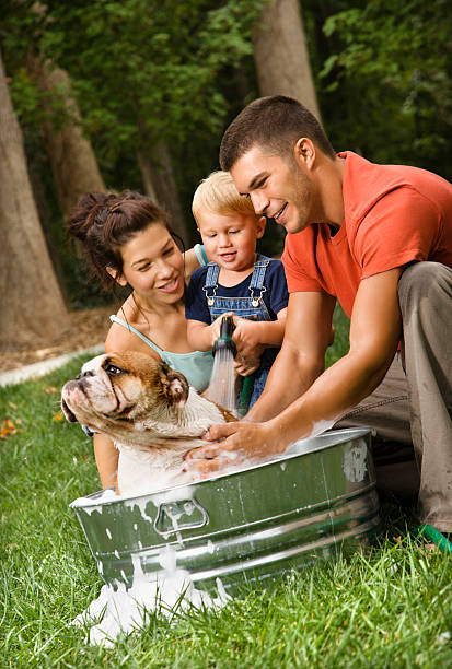 Family giving dog a bath.