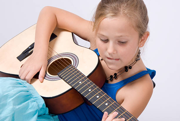 istock Young girl playing acoustic guitar 145055662