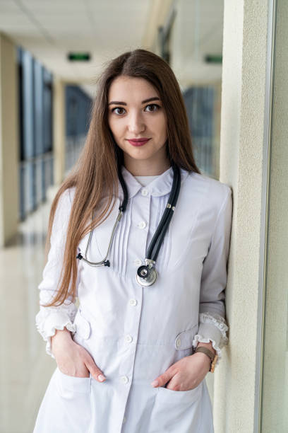 istock experienced nurse in a white lab coat looking at the camera with a smile while posing 1450557007