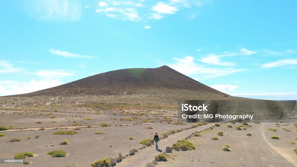 Aerial view of a tourist hiker walking at Montaña Roja, Tenerife Canary Islands. Drone shot Adult Stock Photo