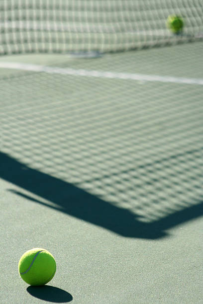 istock Tennis ball with net shadow and white line 145055861