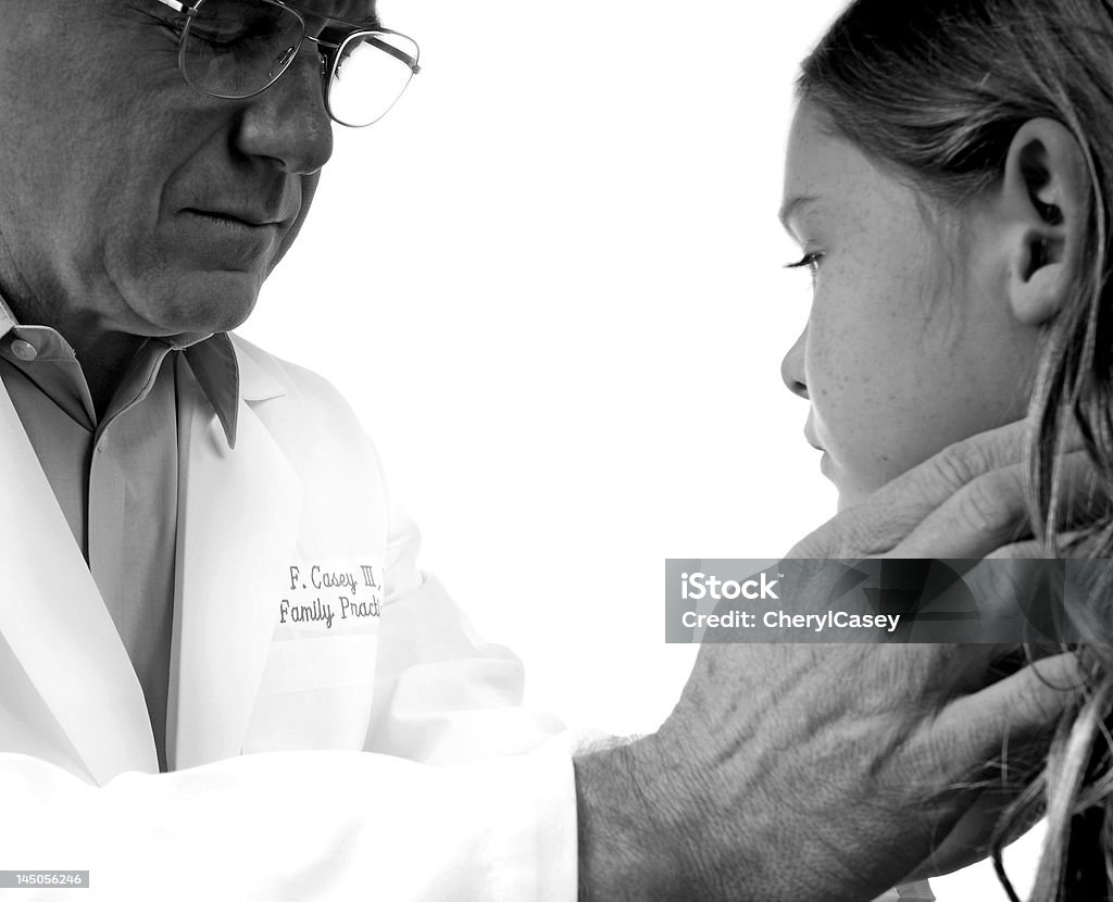 Physical Examination Physician feeling glands on throat of young patient Night Table Stock Photo