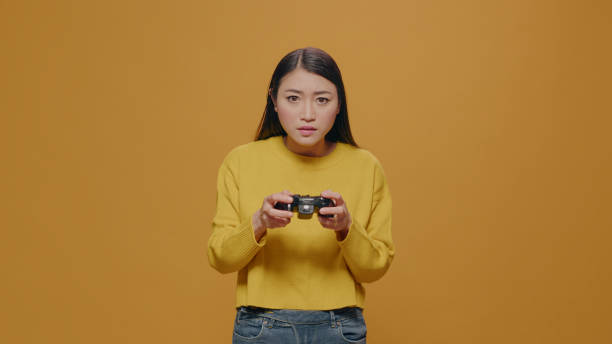 istock Focused person playing video games with controller in front of camera 1450565884