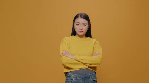 istock Disappointed woman posing with arms crossed on camera 1450566166