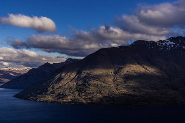 istock Dramatic Light on Queentown's Snow Capped Mountains 1450569101