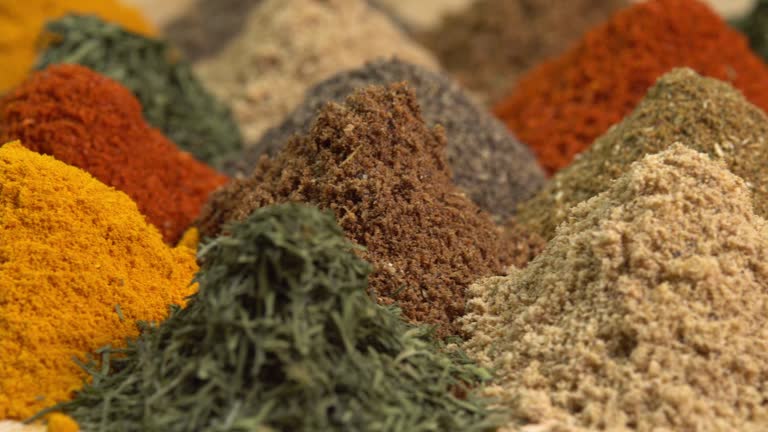 Spice and seasoning. Various fragrant spice market. Heap different Asian Spices rotated on wooden background. Assortment spices and herbs for cooking