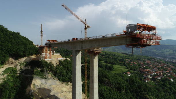 istock Aerial drone view on highway bridge road under construction. Construction of the viaduct on the modern new road. 1450574203